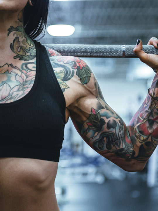 an athlete holding a barbell on their shoulders